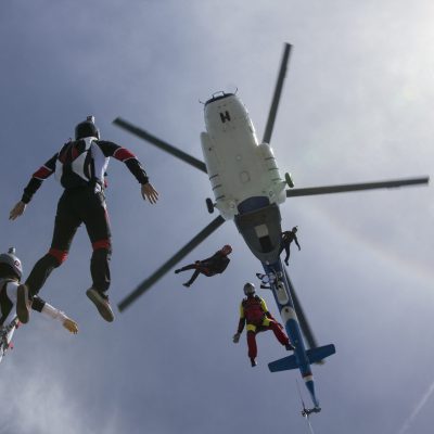 Low angle view of helicopter and six skydivers free falling, Siofok, Somogy, Hungary